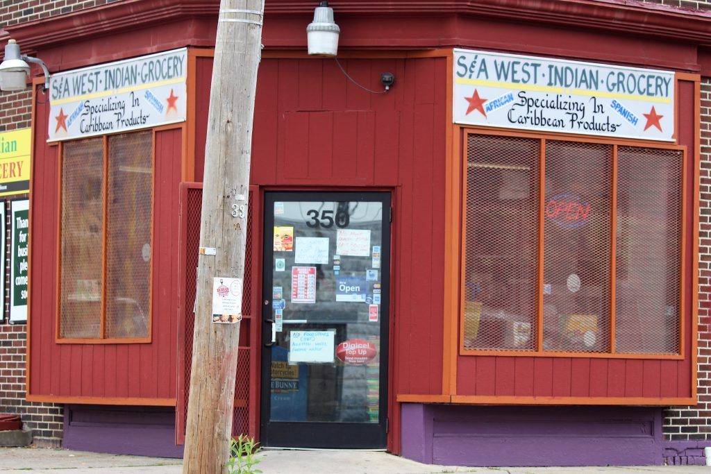 A West Indian grocery storefront, the kind of shop families look for first in a new city