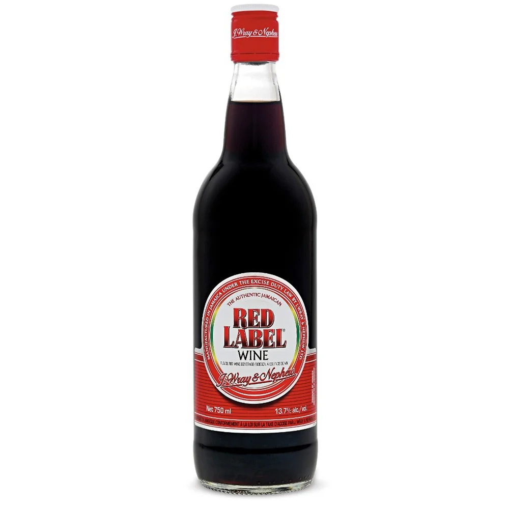 A bottle of red wine, used with rum to soak fruit for black cake
