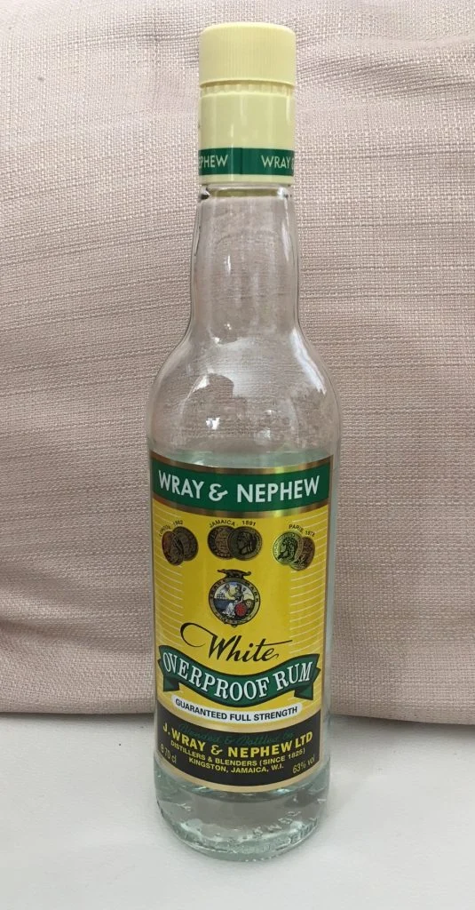 A bottle of Wray & Nephew overproof rum, used to soak fruit and feed black cake as it matures